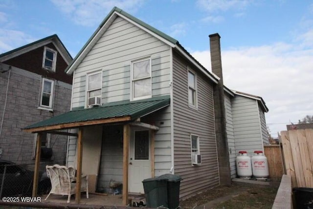 rear view of property featuring cooling unit