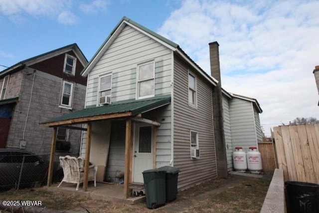 view of front facade with cooling unit and a patio area