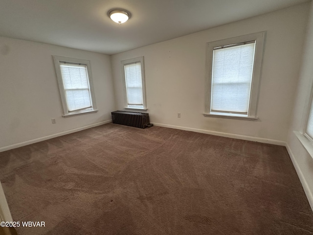 325 Washington Ave, Jersey Shore, PA 17740 - empty room with baseboards, dark carpet, and radiator heating unit