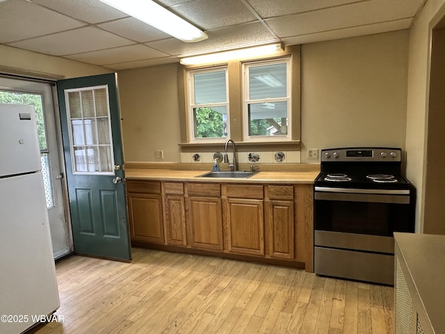 325 Washington Ave, Jersey Shore, PA 17740 - kitchen featuring stainless steel electric range, freestanding refrigerator, a sink, brown cabinets, and a paneled ceiling