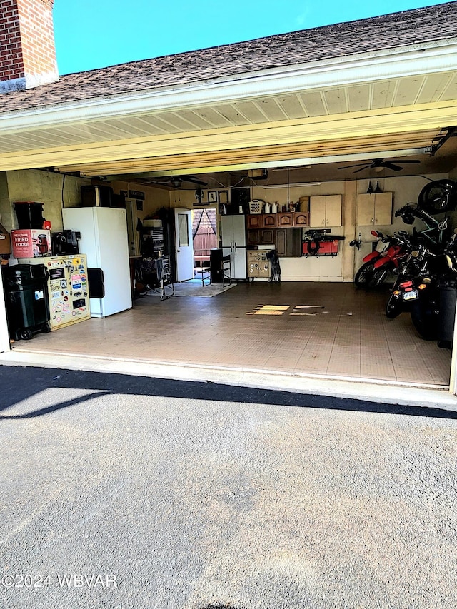 garage with freestanding refrigerator and a garage door opener