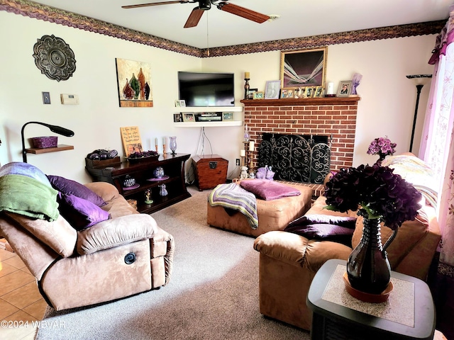 living room featuring tile patterned flooring, a brick fireplace, carpet flooring, and ceiling fan