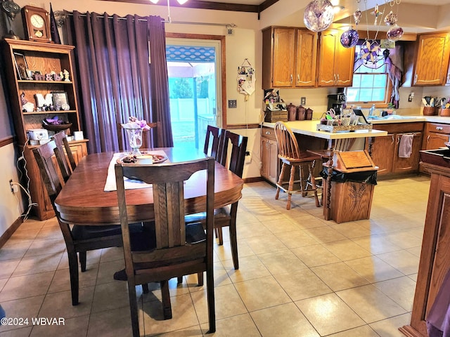 dining room featuring ornamental molding and sink