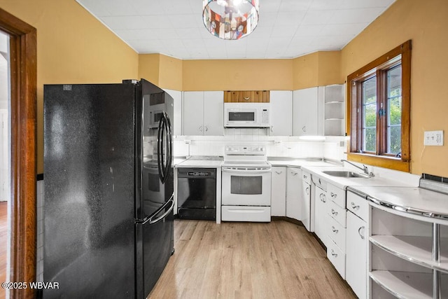 152 Carpenter St, Dushore, PA 18614 - kitchen with black appliances, light wood-style flooring, open shelves, white cabinets, and light countertops