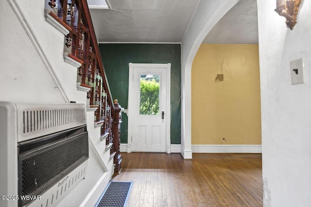 152 Carpenter St, Dushore, PA 18614 - entryway with heating unit, arched walkways, wood-type flooring, and stairway
