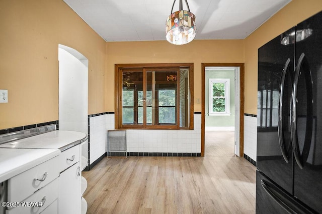 152 Carpenter St, Dushore, PA 18614 - unfurnished dining area with light wood-style floors and a wainscoted wall
