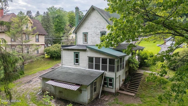 152 Carpenter St, Dushore, PA 18614 - rear view of property with stairs, a sunroom, roof with shingles, and a chimney