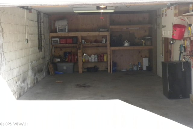 garage with concrete block wall