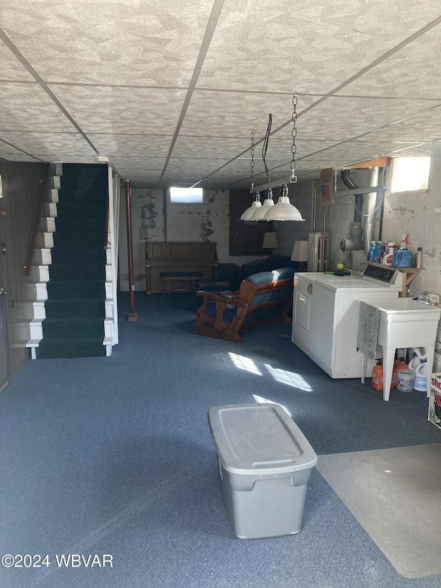 below grade area featuring stairway and washer and clothes dryer