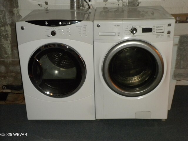 basement with stairs and washer and clothes dryer