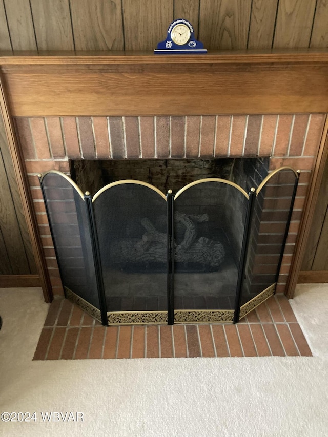 interior details with a brick fireplace