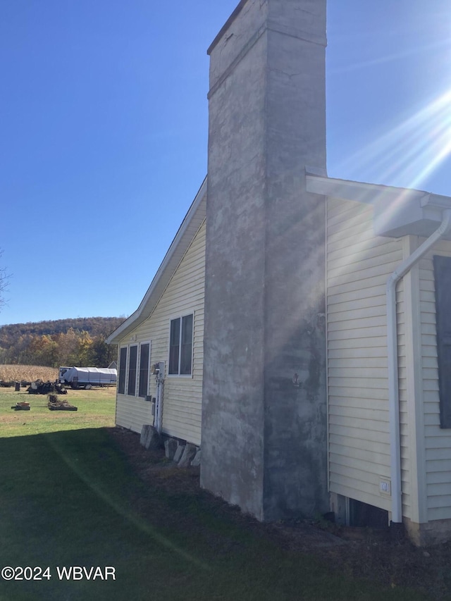 view of property exterior with a yard