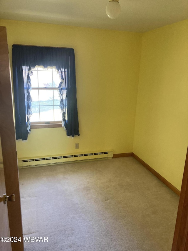 empty room with baseboards, carpet flooring, and baseboard heating