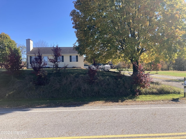 view of front of house featuring a chimney