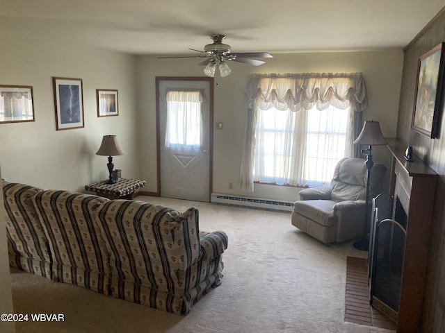 living area with plenty of natural light, baseboard heating, carpet, and a fireplace