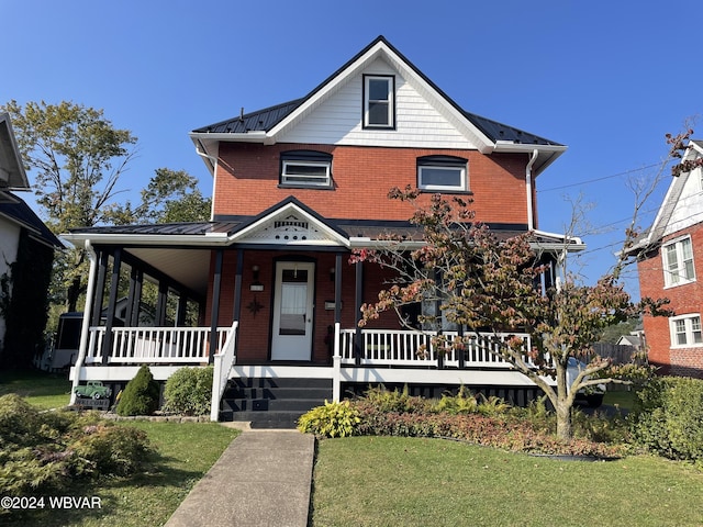 view of front of home with a porch and a front lawn