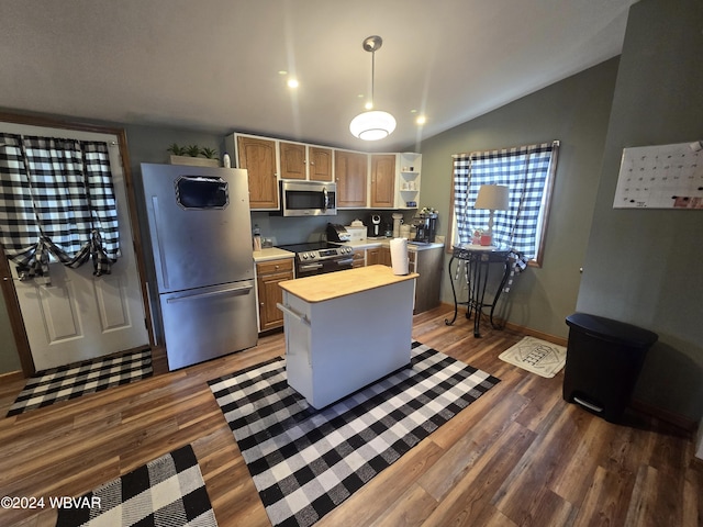 kitchen with a center island, dark hardwood / wood-style flooring, lofted ceiling, and stainless steel appliances