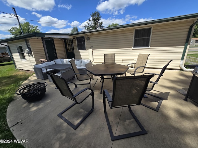 view of patio / terrace with an outdoor living space with a fire pit