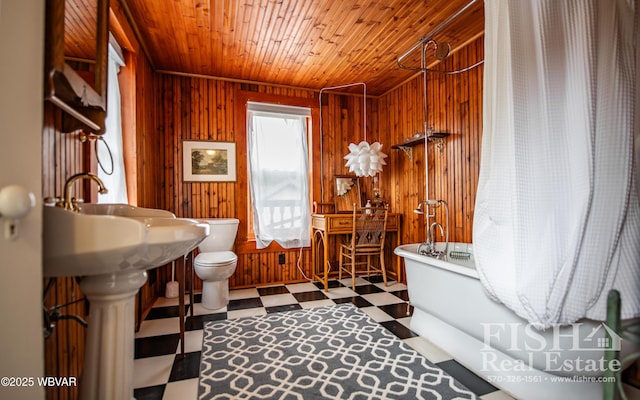 bathroom with wood walls, toilet, wood ceiling, and walk in shower