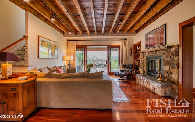 living room with beamed ceiling, dark hardwood / wood-style flooring, wooden ceiling, and a fireplace