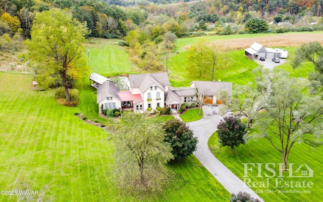 birds eye view of property with a rural view