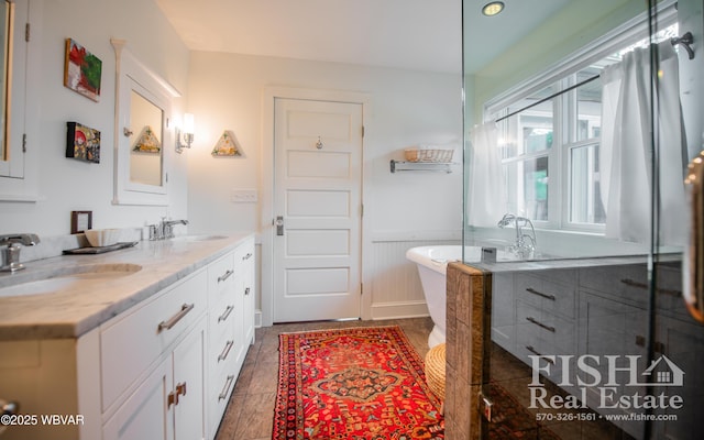 bathroom featuring vanity and a tub