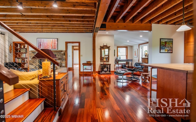 living room with beamed ceiling and dark wood-type flooring