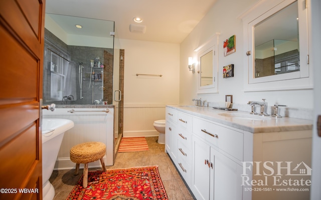 bathroom featuring vanity, toilet, and an enclosed shower