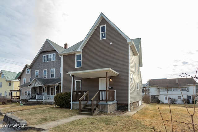 view of front of property featuring covered porch and a front lawn