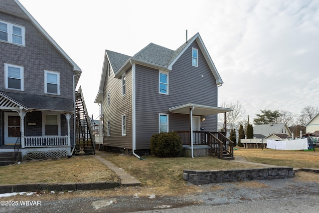 view of front of home featuring a front yard and covered porch