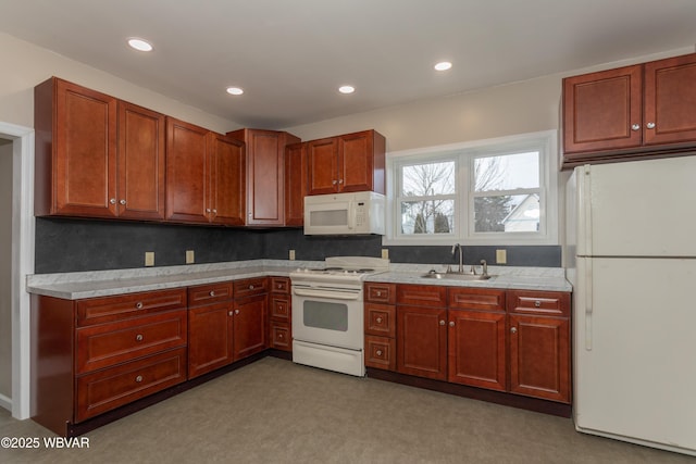 kitchen featuring tasteful backsplash, sink, and white appliances