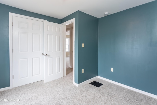 unfurnished bedroom featuring light colored carpet