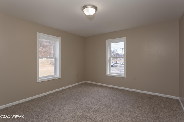 carpeted spare room with a wealth of natural light