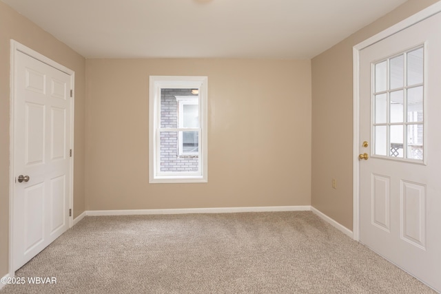 spare room with light colored carpet