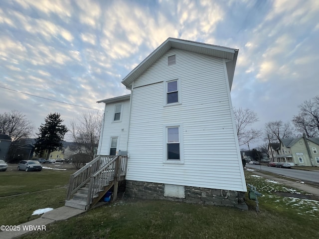 view of side of home featuring a yard