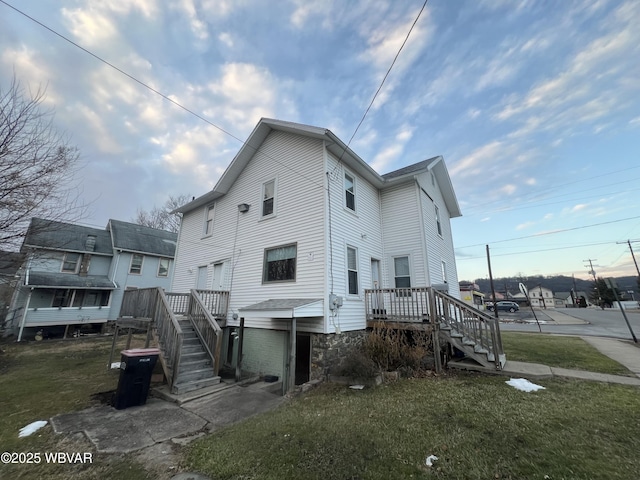 rear view of property featuring a yard