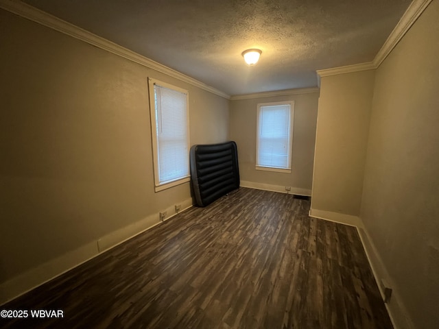 unfurnished room featuring a textured ceiling, dark hardwood / wood-style floors, and crown molding