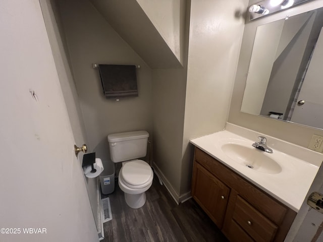 bathroom featuring hardwood / wood-style floors, vanity, and toilet