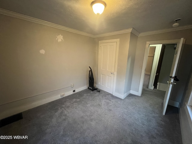 unfurnished bedroom with dark colored carpet, crown molding, and a textured ceiling