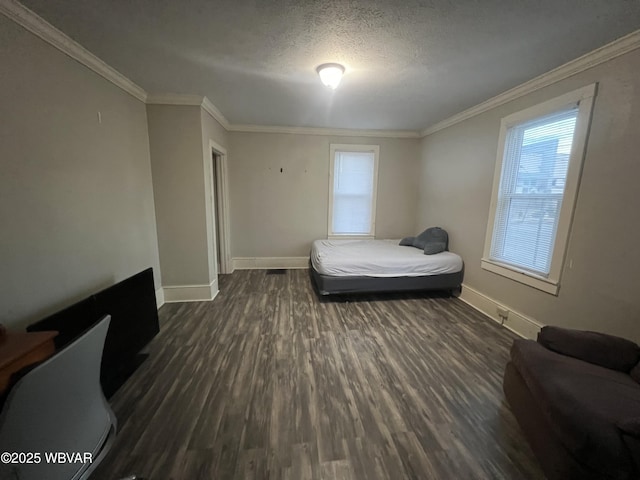 bedroom featuring a textured ceiling, dark wood-type flooring, and crown molding