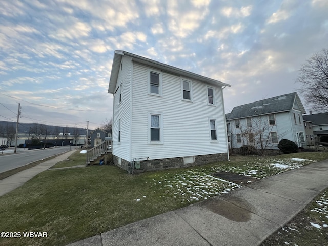 view of side of home with a lawn