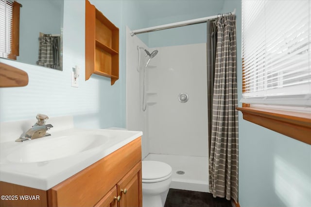 bathroom with a shower with curtain, vanity, and toilet