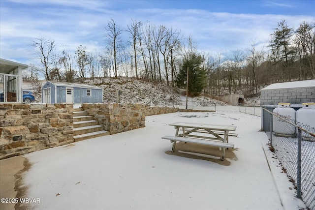 snowy yard featuring an outbuilding