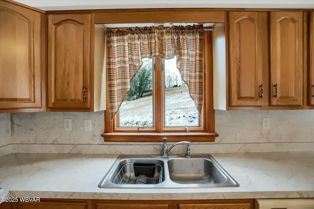 kitchen featuring decorative backsplash and sink