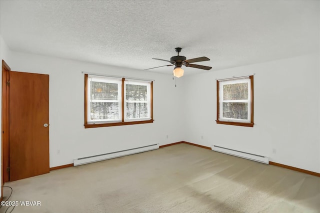 carpeted empty room with ceiling fan, a textured ceiling, and a baseboard heating unit