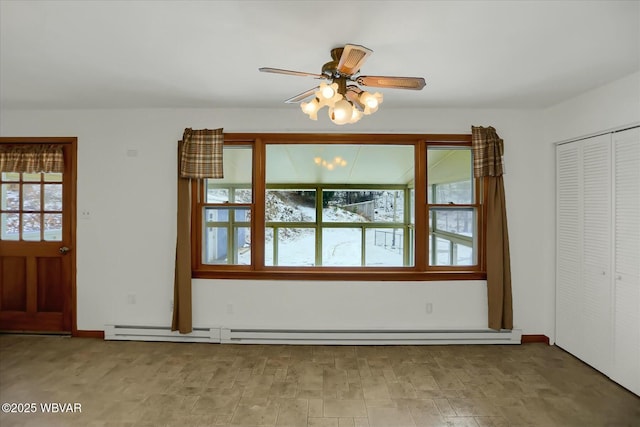 interior space featuring ceiling fan, a healthy amount of sunlight, and a baseboard radiator