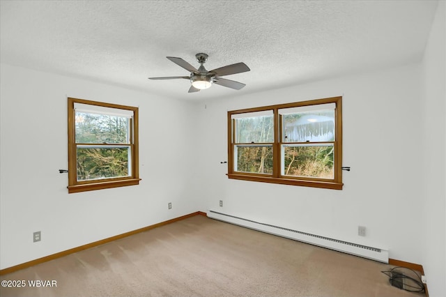 carpeted empty room with baseboard heating, ceiling fan, and a textured ceiling