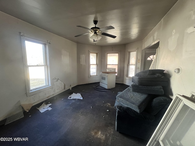 interior space with baseboards and a ceiling fan