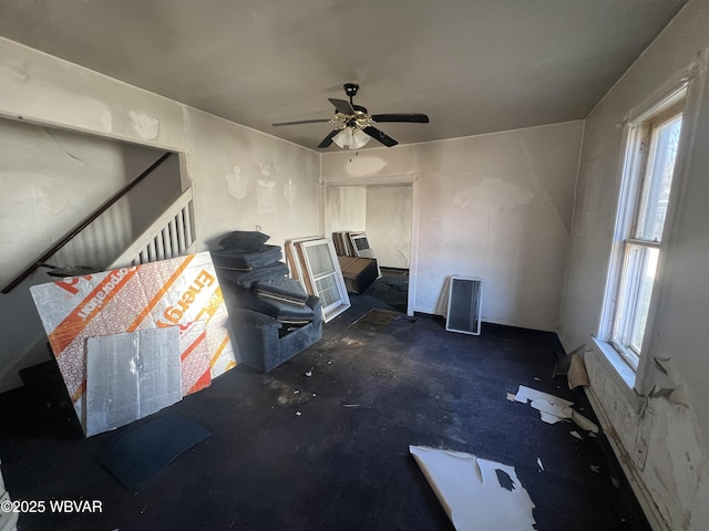 unfurnished living room featuring ceiling fan