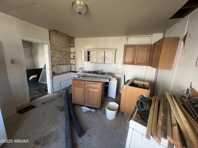 kitchen with brown cabinetry and visible vents